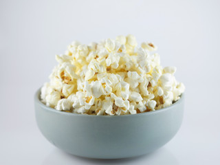 Popcorn in bowl isolated on white background