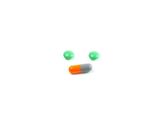green pills and orange capsules isolated white background, Medicines, Tablets, Drug, Healthcare medical