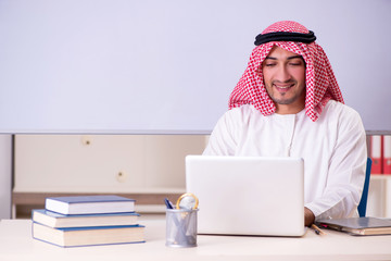 Arab teacher in front of whiteboard 