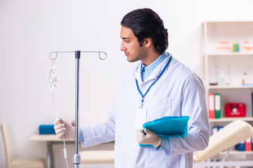 Young male doctor in blood transfusion concept 