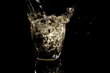 Glass of water on black background