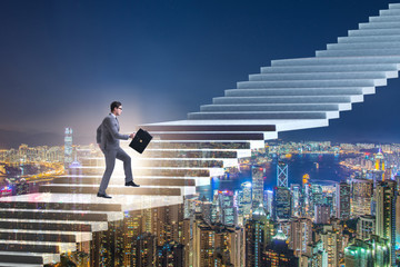 Businessman climbing career ladder over city