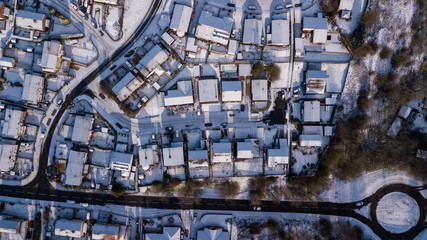 Top down aerial view of a Welsh town covered in fresh white snow (Ebbw Vale, Wales, UK)