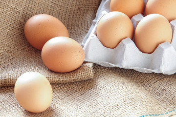 Pile of Brown fresh egg on brown fabric