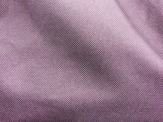 beautiful luxury silver pink cloth background, detail of wavy pink opaque fabric background, background of closeup crumpled textile bronze pink color