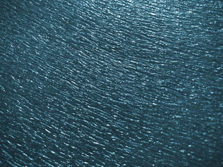 beautiful texture emboss blurred background of close up foam sheet in dark blue color, plastic foam sheet background dark turquoise color, focus and blurred texture background dark blue color