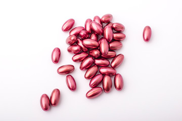 handful of oval, purple tablets lie on a light background. concept of medicine, drugs and vitamins