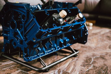 V8 Engine block table, painted in blue color. Loft stylish table furniture with tempered glass