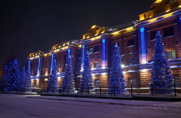 Fototapeta na wymiar Administrative building, the former provincial classical male gymnasium dressed up Christmas lights in Tomsk.