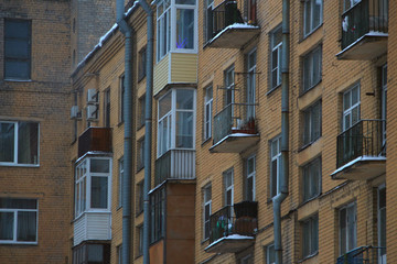 Fototapeta na wymiar windows and balconies of a brick house