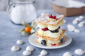 Tea and sweets on a light background, Mille-feuille, Eclairs, Tart, Decorative with flowers, Selective focus, Closeup