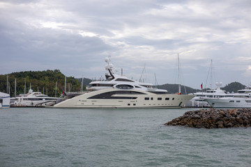 Fototapeta premium The exotic big white superyachts in port. Thailand. Photo with noise