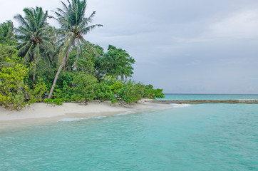 the island of Maldives of Fiholhohi a landscape the beach with azure water of the Indian Ocean in cloudy day