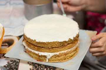 application of milk cream on the surface of the sweet cake