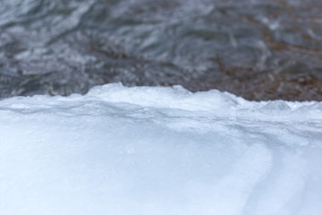 stone on ice in a frozen lake