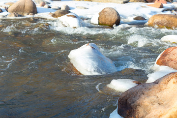 Mountain river and stones in winter