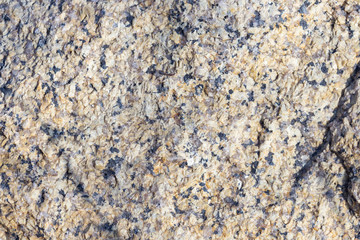 Stone surface of a dark yellow sandstone, background, texture
