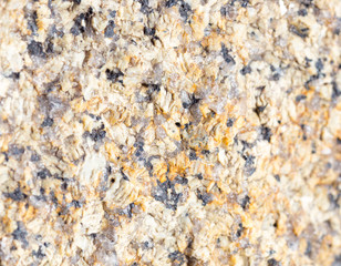 Stone surface of a dark yellow sandstone, background, texture