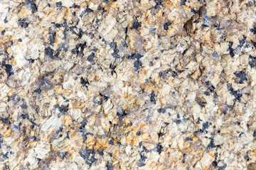 Stone surface of a dark yellow sandstone, background, texture