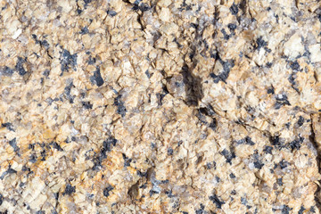 Stone surface of a dark yellow sandstone, background, texture