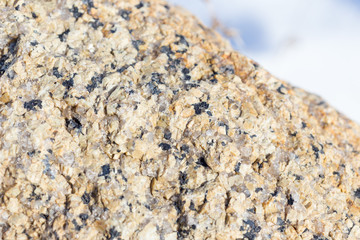 Stone surface of a dark yellow sandstone, background, texture