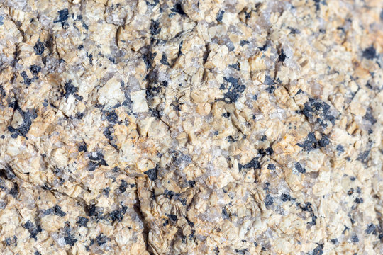 Stone surface of a dark yellow sandstone, background, texture