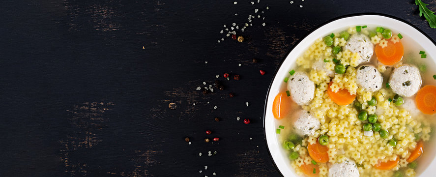 Italian Meatball Soup And  Stelline  Gluten Free Pasta In Bowl On Black Table. Dietary Soup. Baby Menu. Tasty Food. Top View. Banner