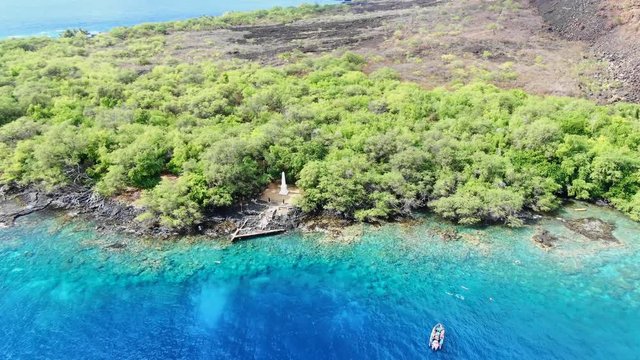 Stunning aerial drone footage of the Captain James Cook monument in Kealakekua Bay, Big Island, Hawaii.The monument marks the spot where James Cook was killed in a fight with native Hawaiians in 1779.