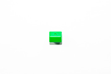 View from the top of the plastic miniature house in green as a part of the monopoly game on a white isolated background