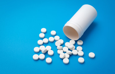 White pills abstract on a blue background