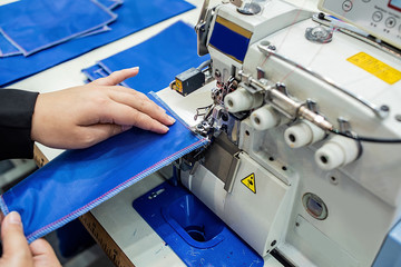Overlock sewing machine / seaming machine / edger in garment factory workshop