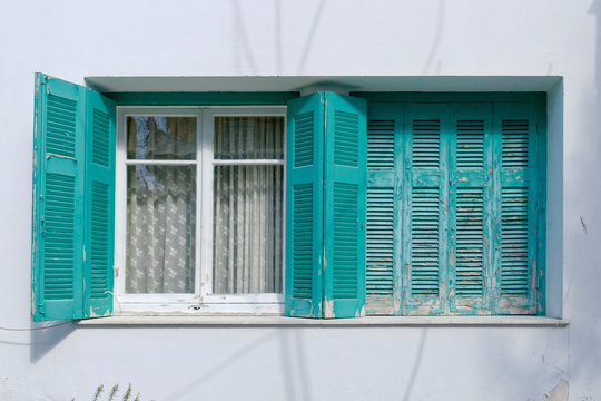 two light green windows on white wall