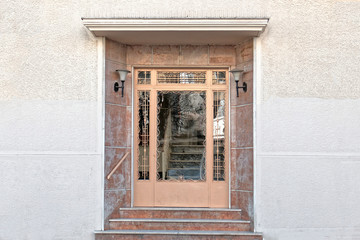 Fototapeta na wymiar Greece Athens downtown, 60's elegant condominium entrance pale pink door