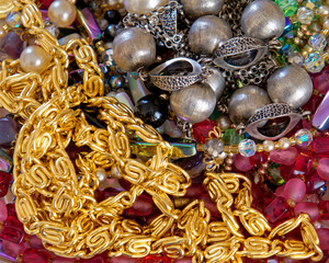 golden and colorful jewerly and pearls top view