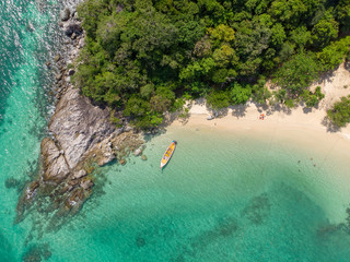 yellow boat  in beautiful turquoise ocean near  green island, top view, aerial photo.Tourists are sunbathing. Phuket. Thailand