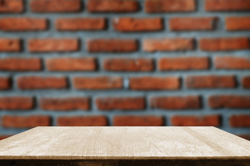 empty wooden table with red brick wall background.