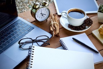 cup of coffee and pen on notebook