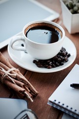 Desk work laptop notebook pen and coffee cup hot on wooden table
