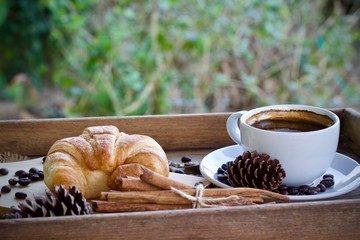cup of coffee and fresh croissants