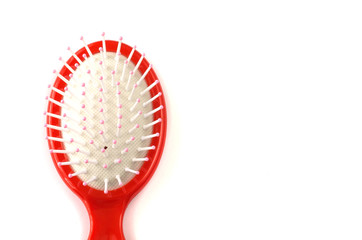 Elegant red hairbrush with handle isolated on white background.