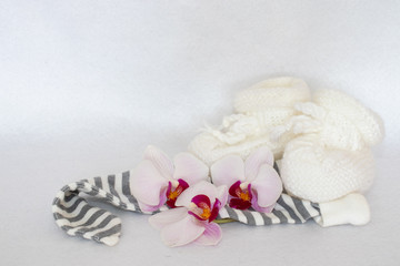 white booties with orchid flowers