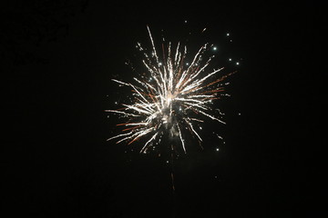 Fototapeta premium several colors of firework exploding in the sky in Nieuwerkerk aan den IJssel in the Netherlands during new years eve.