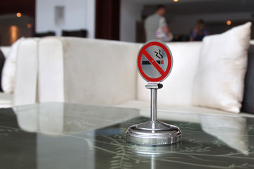 No smoking sign on the stone table in public place