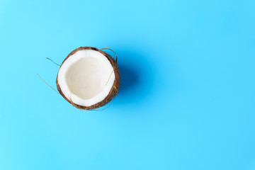 summer background, tropical beach, vacation, fruit minimal concept. creative layout of coconut on bright blue background with copy space