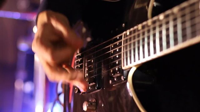 Man plays guitar at rock concert