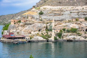 view of Sunken mosque and houses of the town Halfeti in Sanliurfa - Urfa, Turkey. The town and mosque has remained under the birecik dam water of a reservoir on the Euphrates.