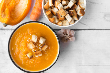 pumpkin soup with crackers, vegetable soup, a piece of pumpkin,