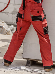 Person wearing red worker trousers