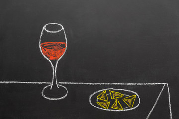 drawing of a glass of wine and Hamantaschen cookies, made with chalk on a blackboard, with copy space