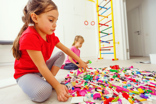 Happy Children Playing With Blocks At Home Or Daycare. Playing Designer Game Of Building A Skyscraper. Architectural Game As Educational Toy For Preschool And Kindergarten.